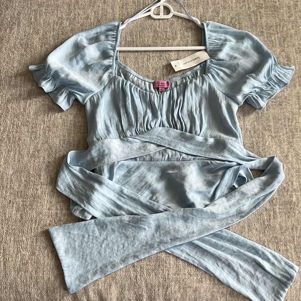 Francesca’s size small baby blue satin blouse with tie in back